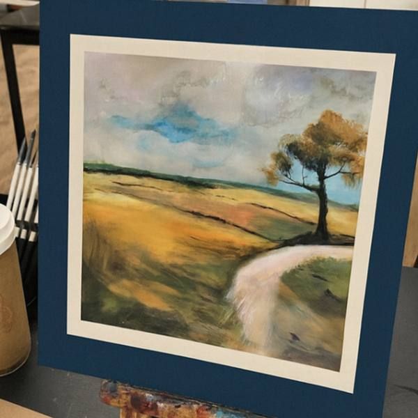 Mounted watercolour landscape with a tree