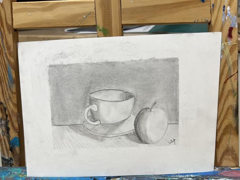 Teen pencil still life of a cup and apple on an easel