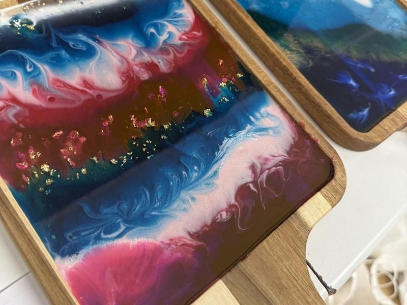 Finished resin serving boards in pink, blue and gold from a Friday resin workshop